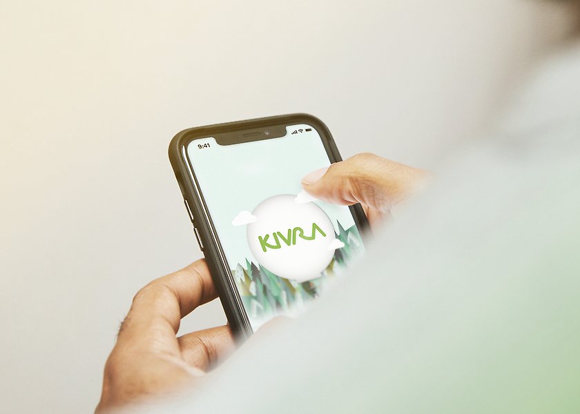 Närbild på händer som håller i en mobil med appen Kivra på skärmen