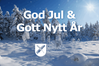 Ett foto på snötyngda granar och vit text som lyder God Jul och Gott nytt år samt Munkedals kommuns logga i vitt. Bilden är även rörlig med snöflingor som singlar ned. 